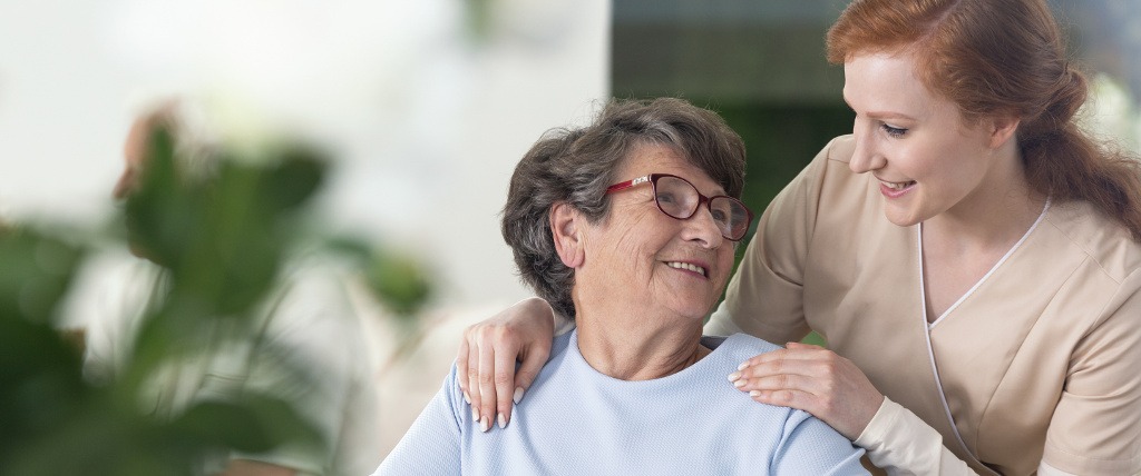 A community health educator speaks with an older adult about wellness and healthy living.